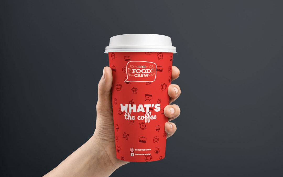 professional catering in sandyford hand holding a red the food crew disposable coffee cup